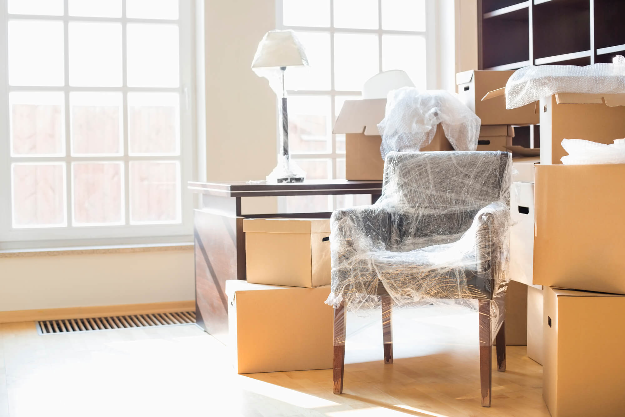 Chair wrapped up in bubble packing and stacked boxes