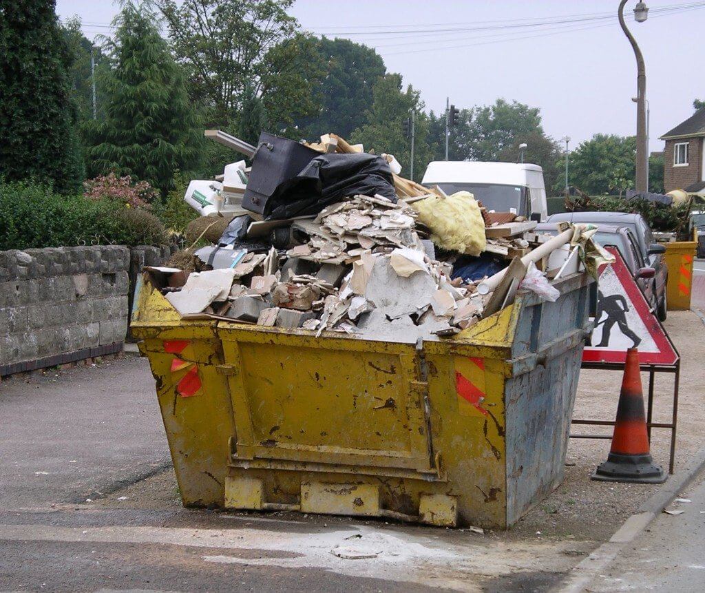 yellow skip full of rubbish