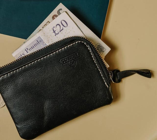 £20 note in a black wallet