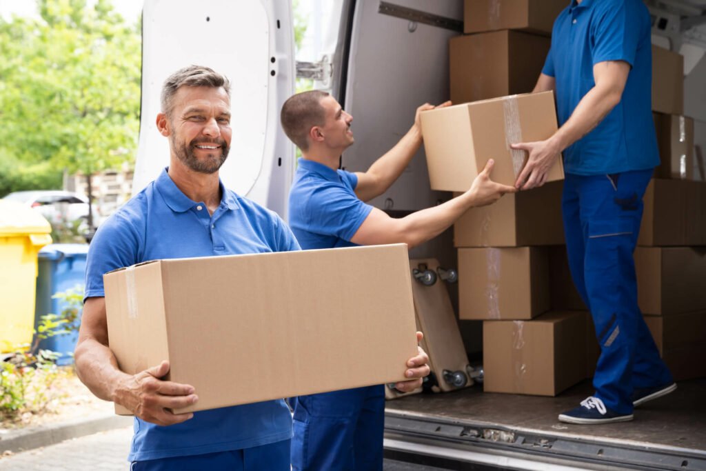 Movers carry box out of van