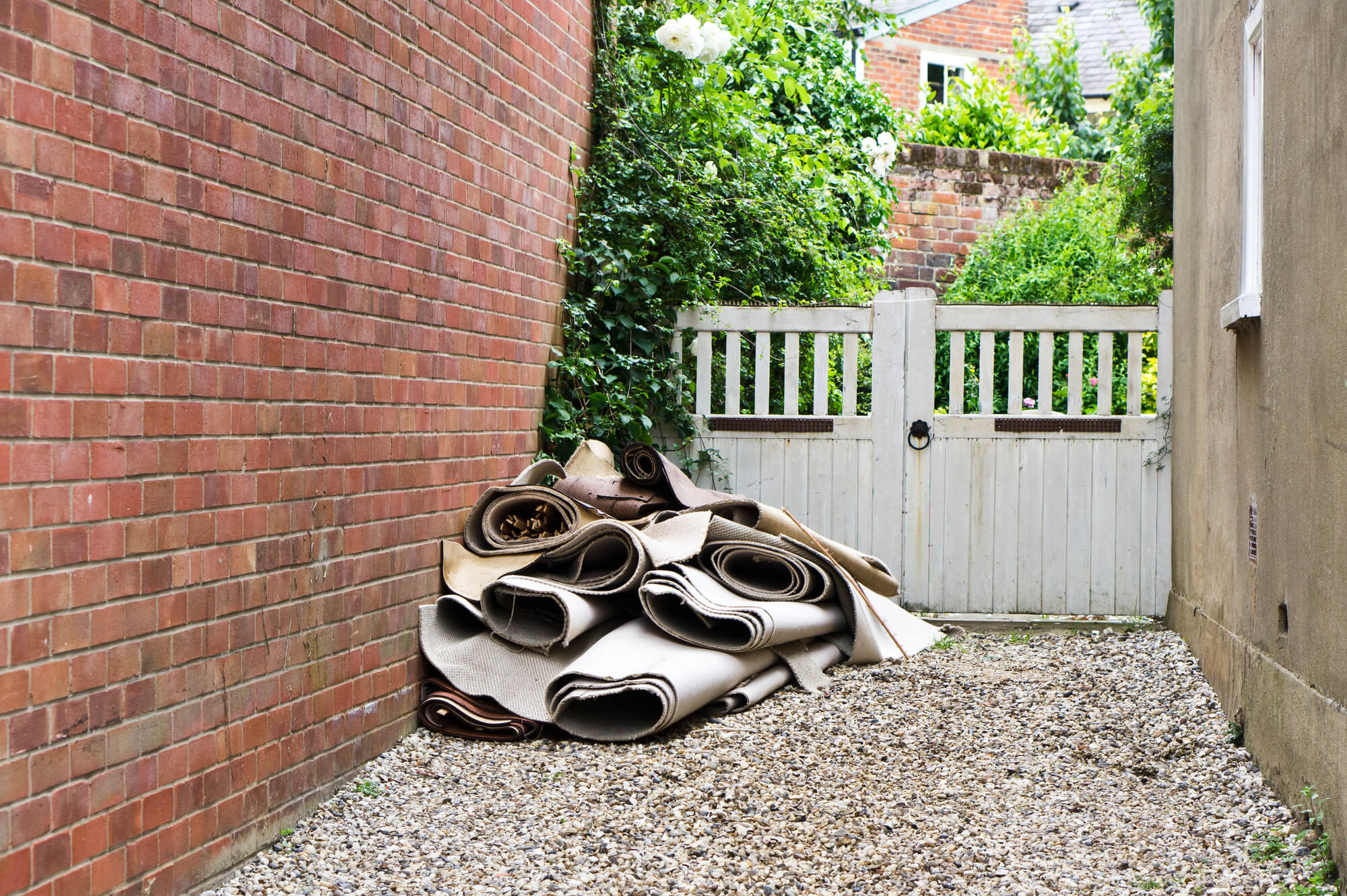 Pile of carpet rubbish next to house